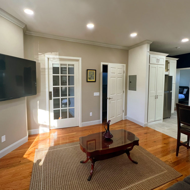 View of living room, TV, entrance and bedroom from inside